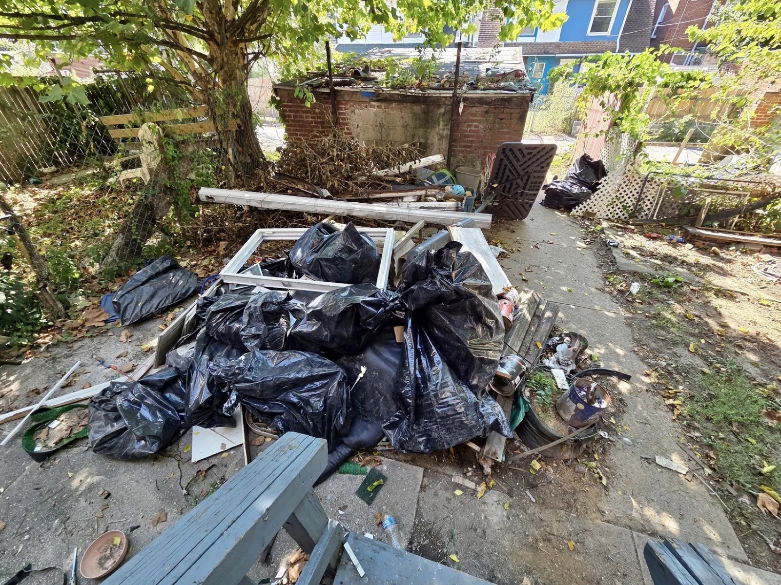 A backyard junk removal by TipTop, before
