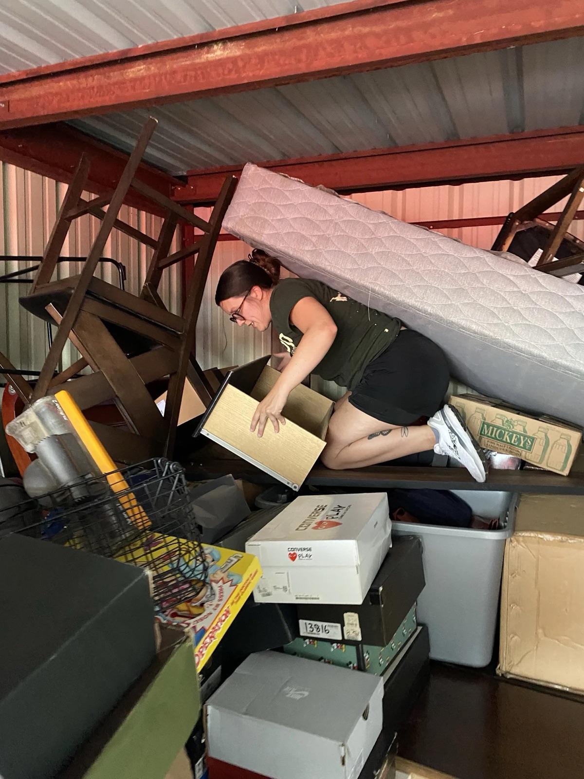 A TipTop team member organizing a packed storage unit